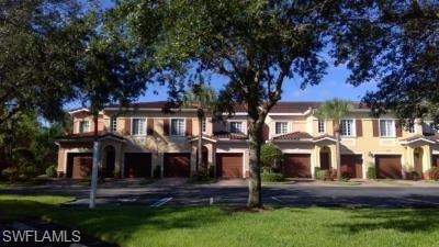 View of front of house featuring driveway, a front lawn, and an attached garage