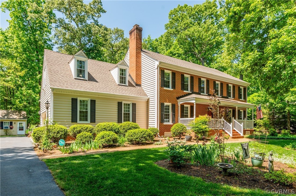 Colonial house featuring covered porch and a front