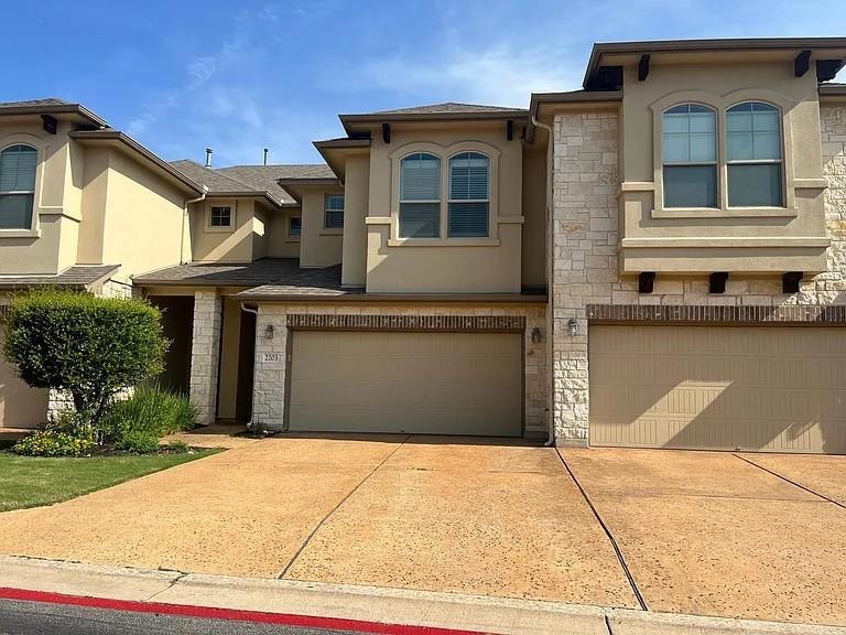View of front of home featuring stucco siding, st