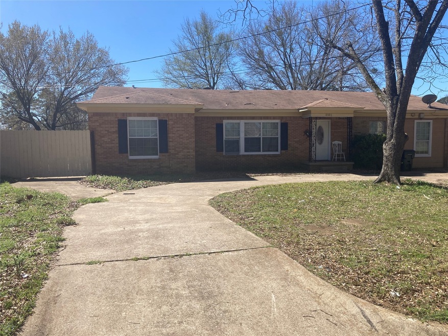 Front of the house with extra driveway gate