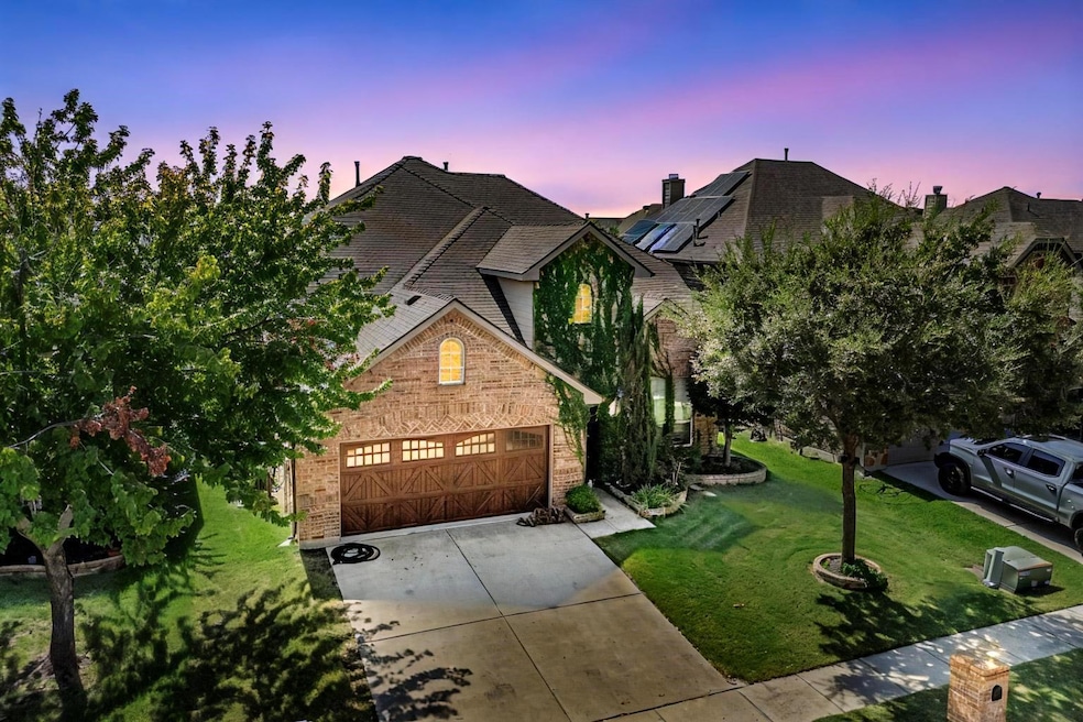 View of front facade with a garage and a lawn