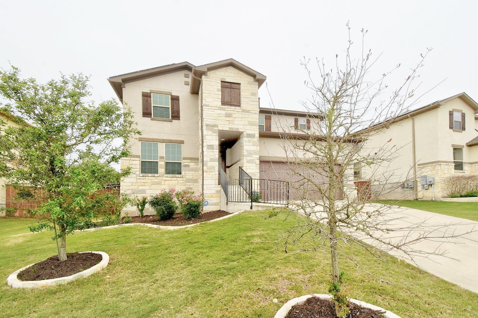 View of front of house featuring driveway, stone 