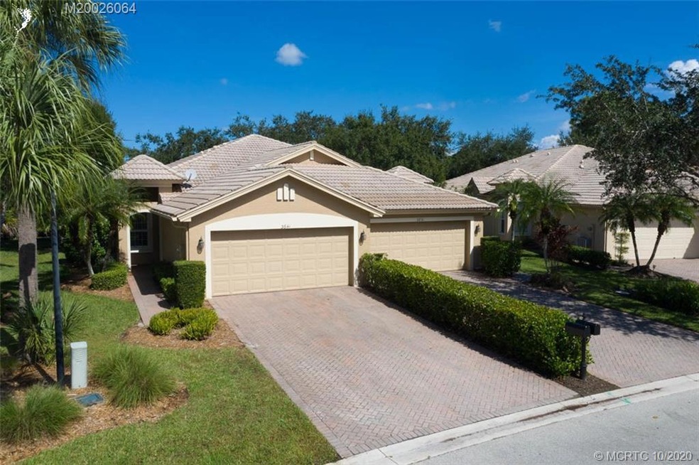 Exceptional updated and upgraded villa...paver driveway, walk, barrel tile roof & covered private entry!