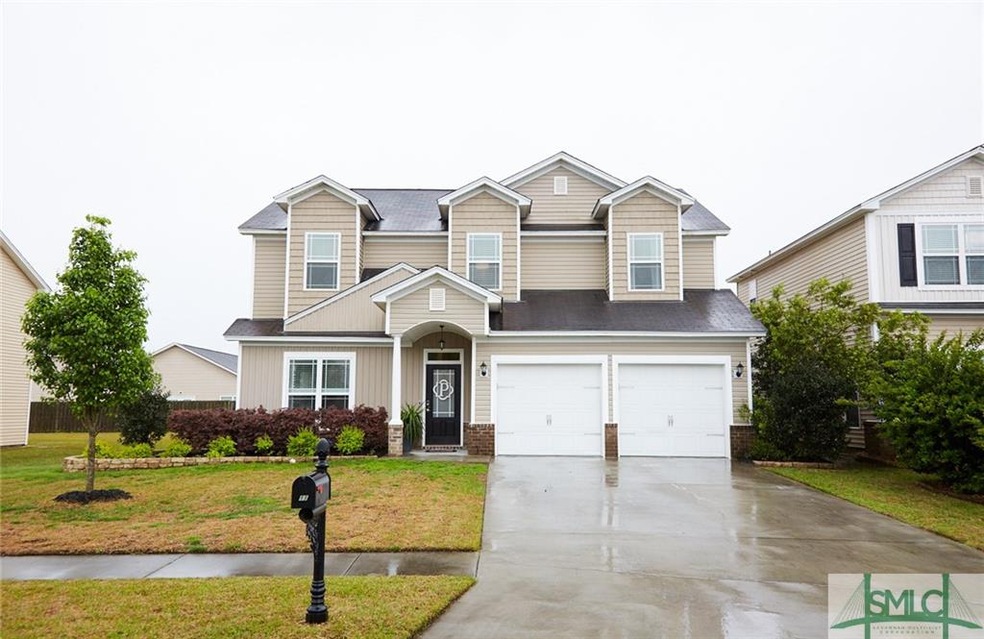 EXTERIOR FRONT: Driveway with two car garage. Side