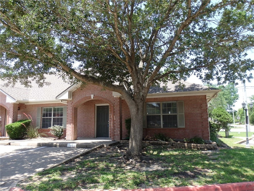 View of front of home featuring brick siding, unco