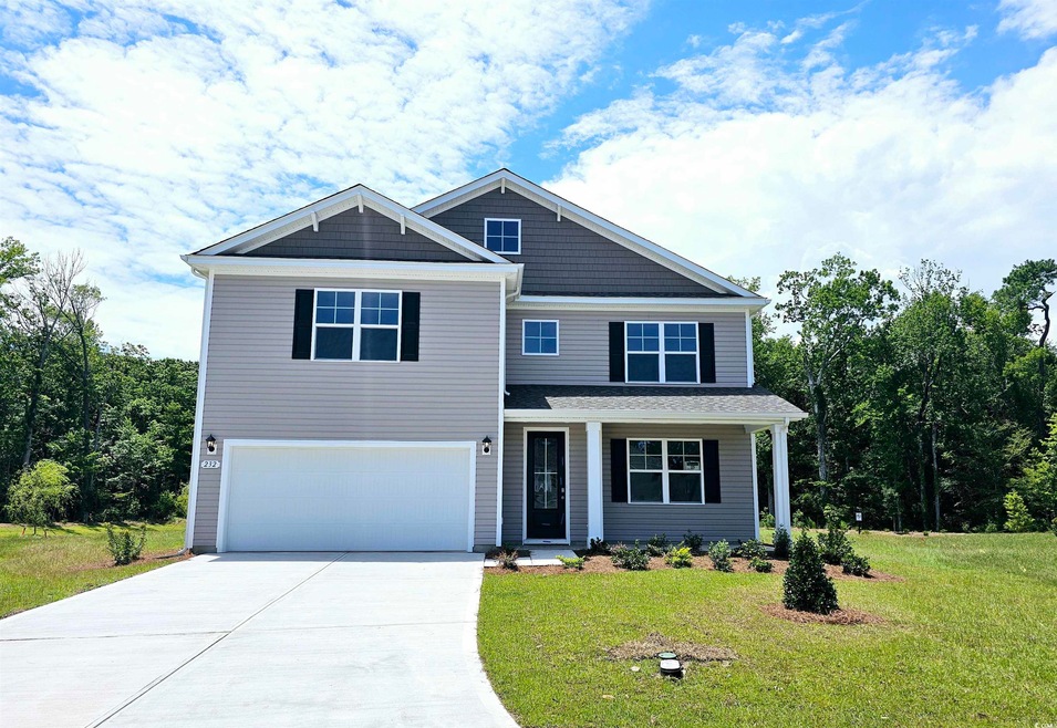 View of front facade with a garage and a front yar
