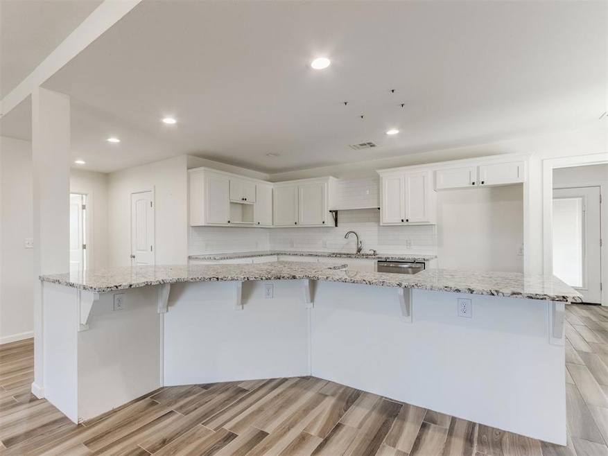 Kitchen with recessed lighting, wood finish floors