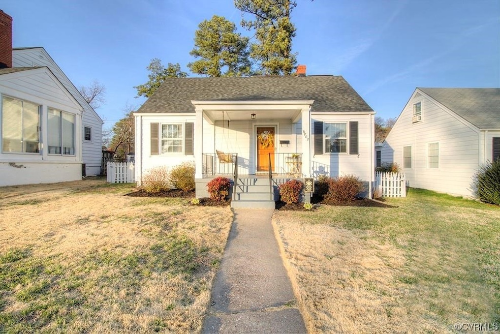 Bungalow with a front lawn and a porch