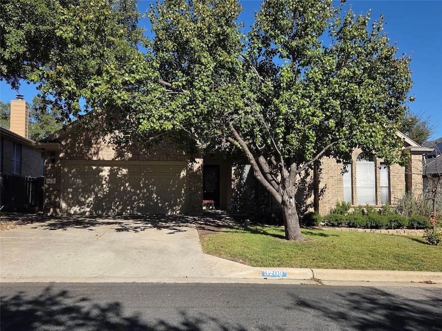 Obstructed view of property featuring brick sidin