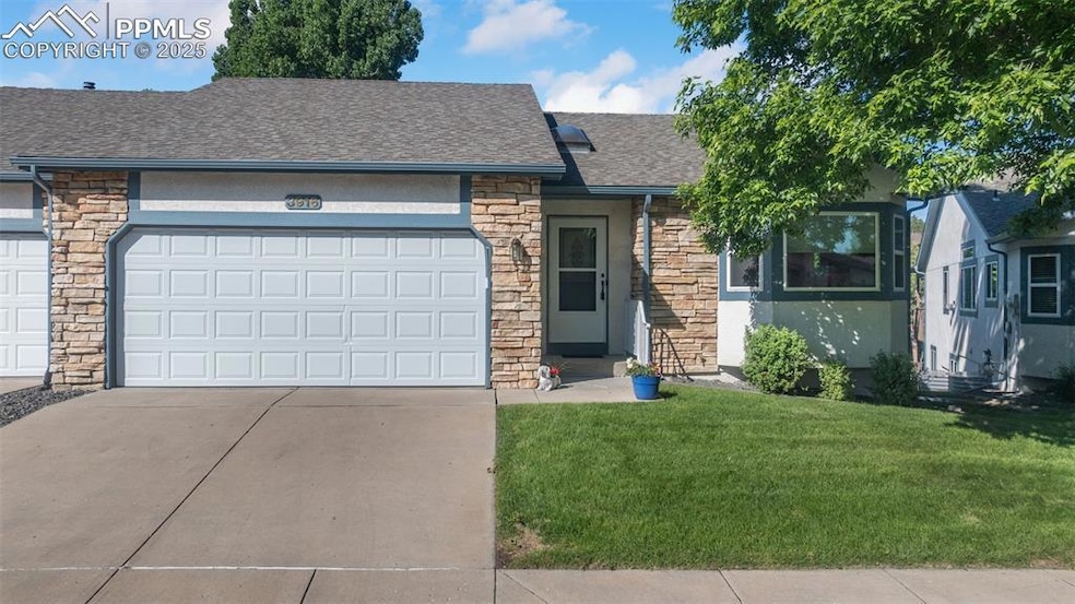 Ranch-style home featuring stone siding, roof with shingles, driveway, and a front yard