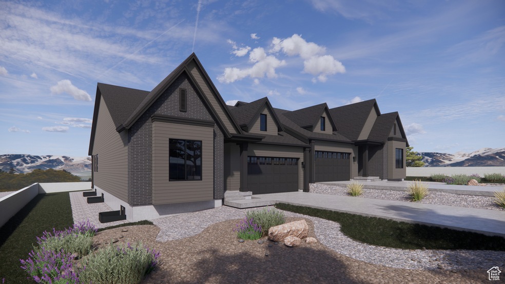 View of front of home featuring a mountain view, concrete driveway, and a garage
