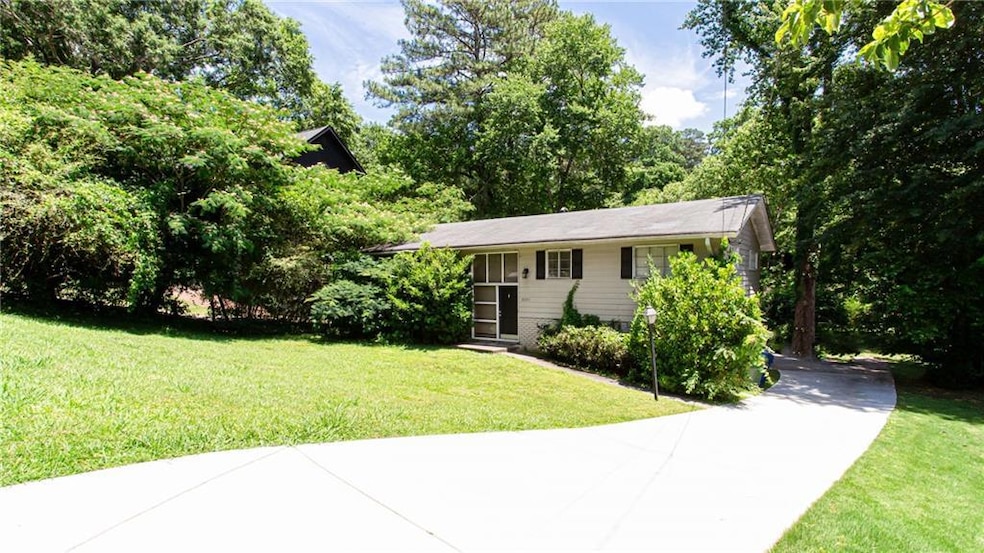 View of front of house with concrete driveway and a front lawn