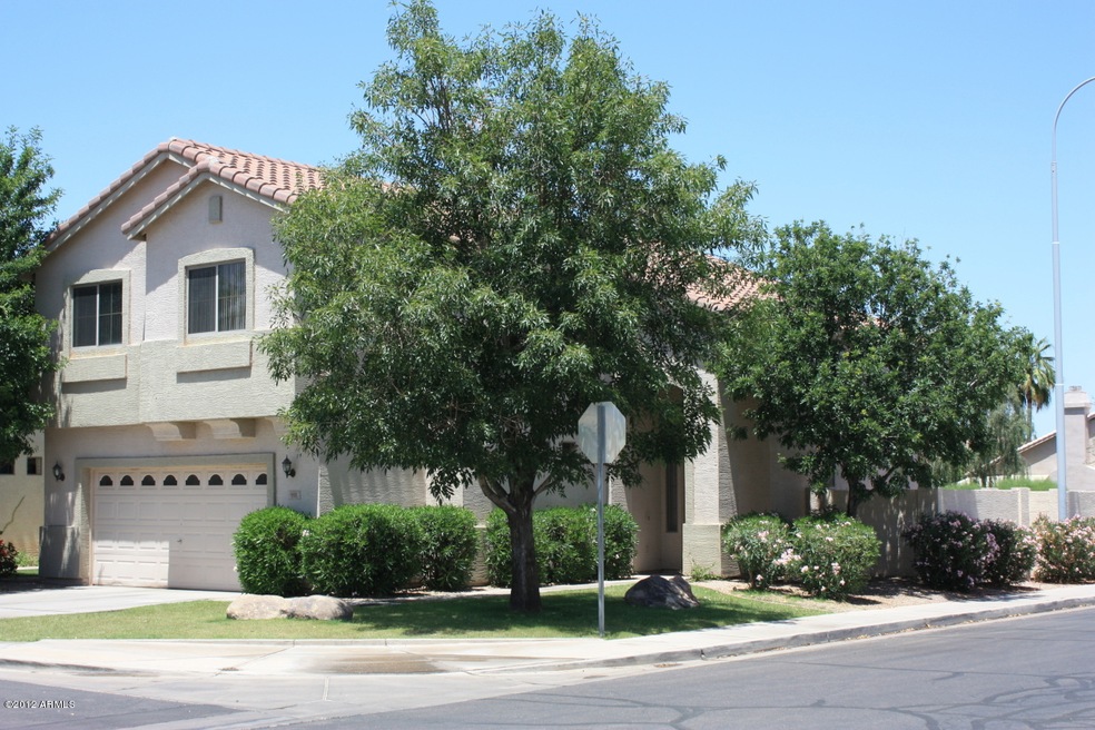 Home on corner lot with mature trees