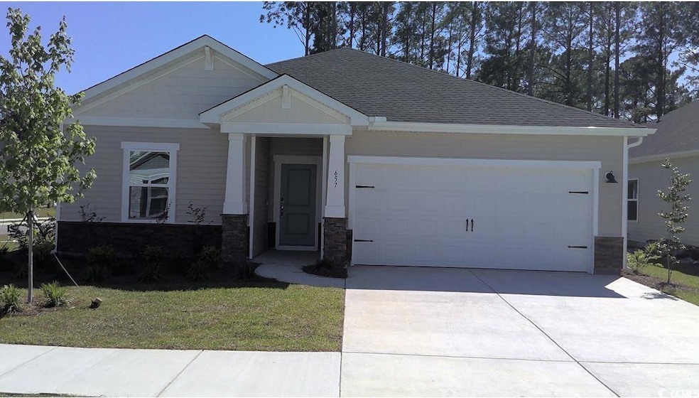 View of front of house featuring concrete driveway