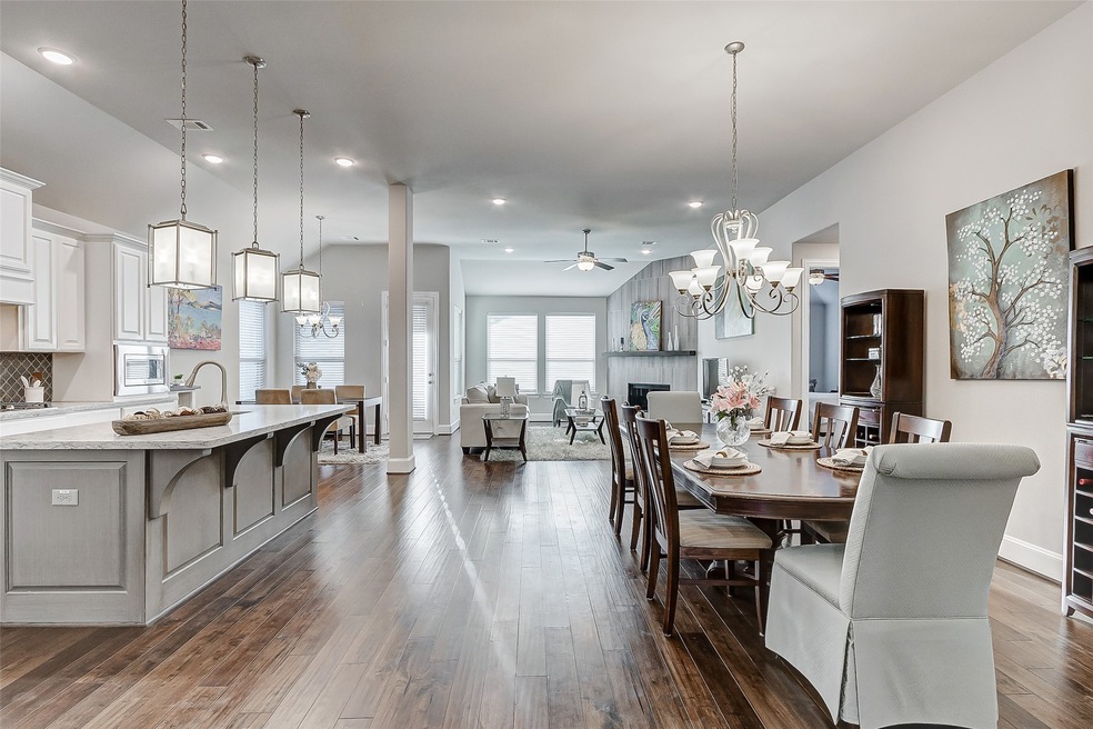 2710 Dogwood is your dream open-concept home! High ceiling with plenty of natural light reflects beautifully on the wood floors that extend through the social areas.