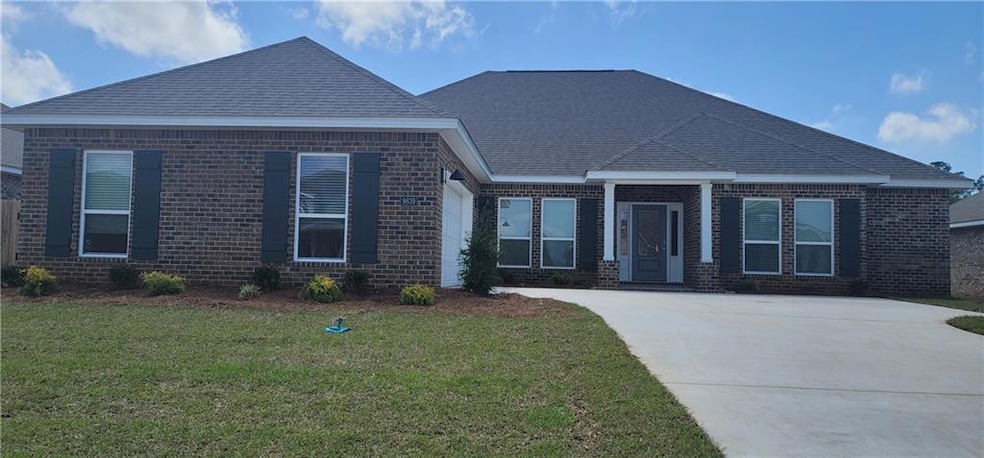 View of front facade featuring driveway, brick sid