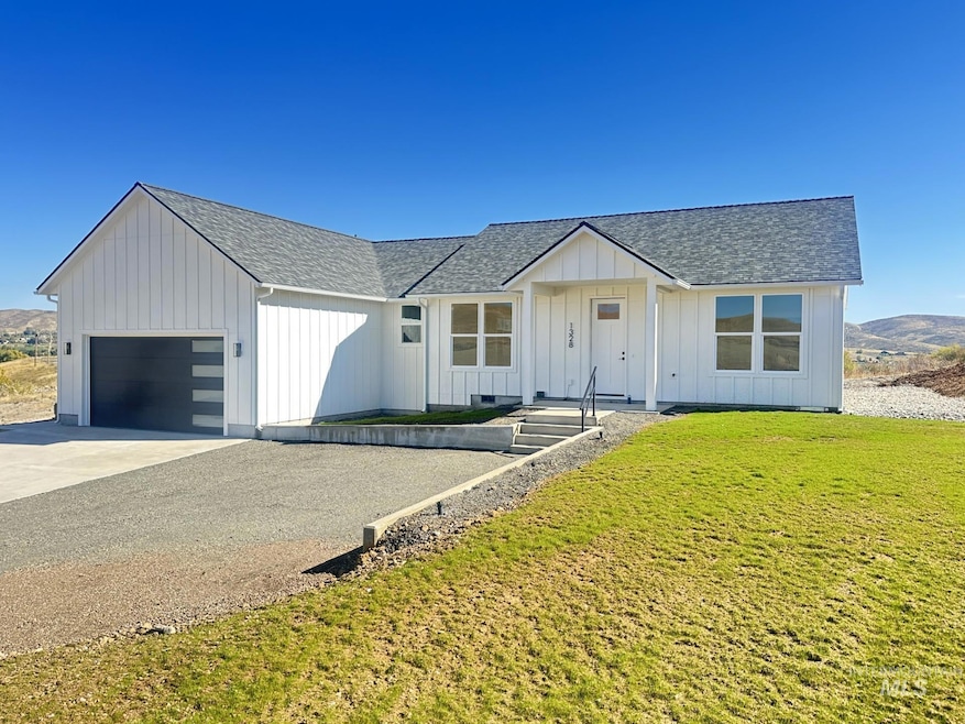 Modern farmhouse style home featuring a shingled roof, board and batten siding, concrete driveway, a front lawn, and a garage