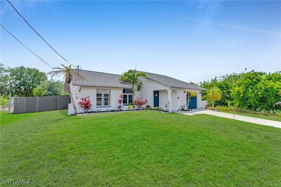Single story home featuring concrete driveway, an