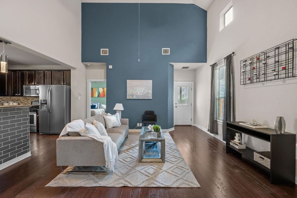 Living room featuring a towering ceiling, healthy