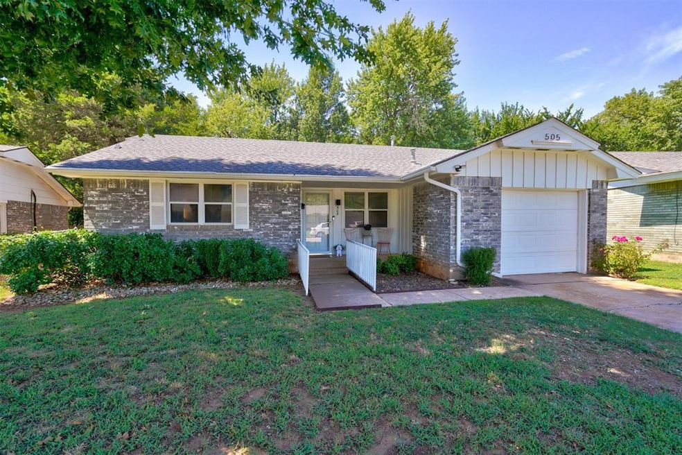 Single story home featuring a front lawn, a garage