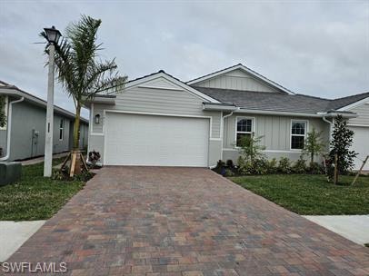 Ranch-style house with a garage, decorative drivew