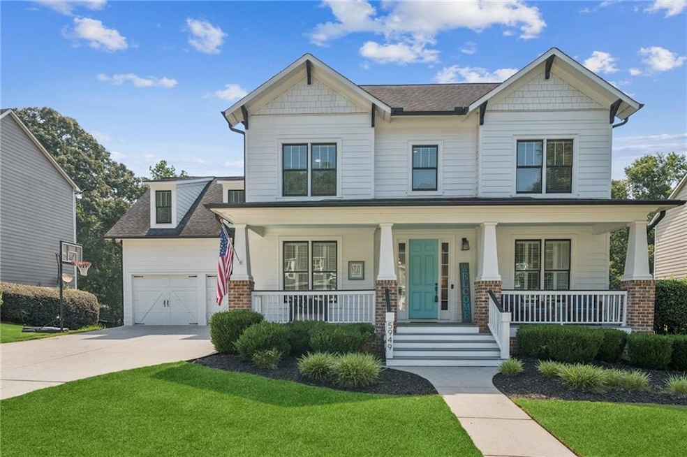Craftsman-style home featuring a porch, a front yard, driveway, and roof with shingles