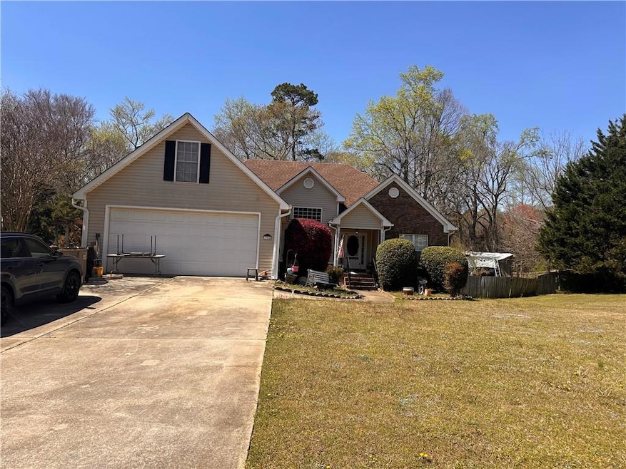 Traditional home featuring concrete driveway, a ga
