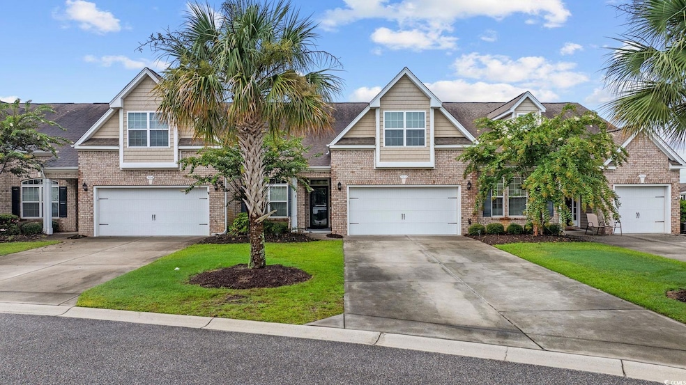 Craftsman inspired home with concrete driveway, a garage, a front yard, and brick siding