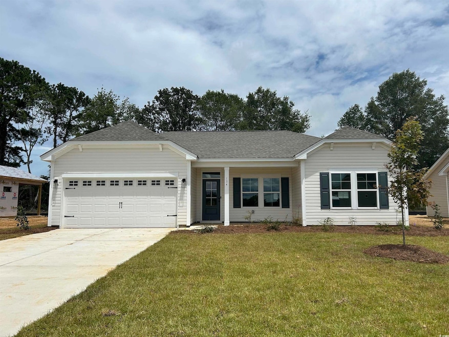 Single story home featuring concrete driveway, an attached garage, a front yard, and roof with shingles