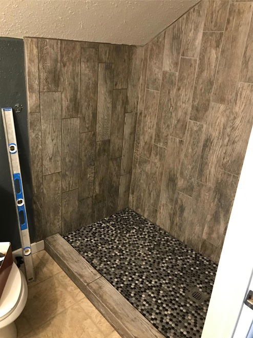 Bathroom with a tile shower and toilet