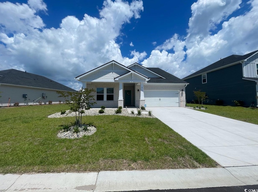 Craftsman inspired home with brick siding, drivewa