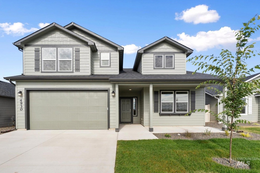 View of front of house with covered porch, driveway, a front yard, an attached garage, and roof with shingles