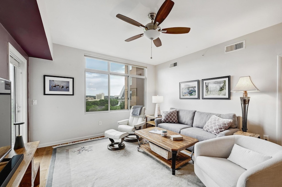 Living room with ceiling fan, wood finished floor