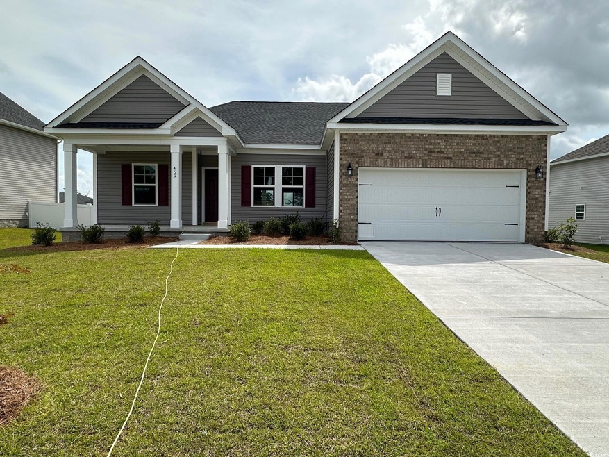 Craftsman inspired home featuring a garage and a f
