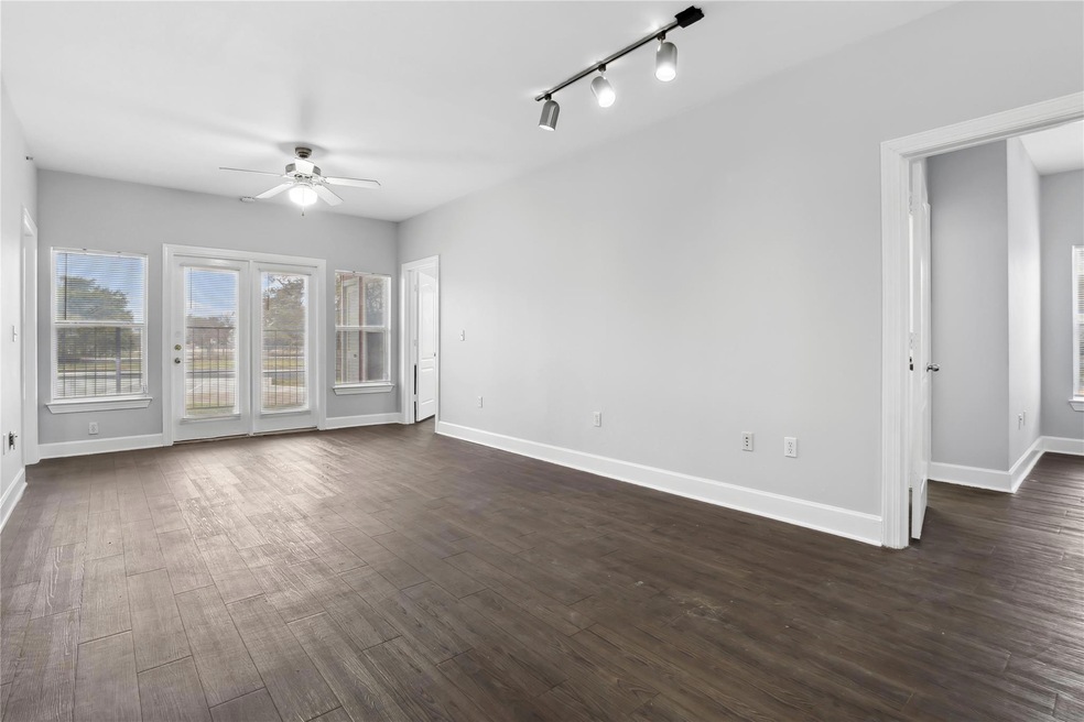 Unfurnished living room featuring dark wood-type 