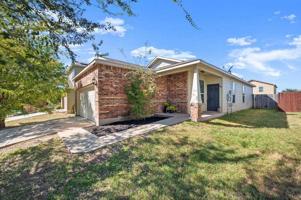 View of front of house with driveway, brick sidin