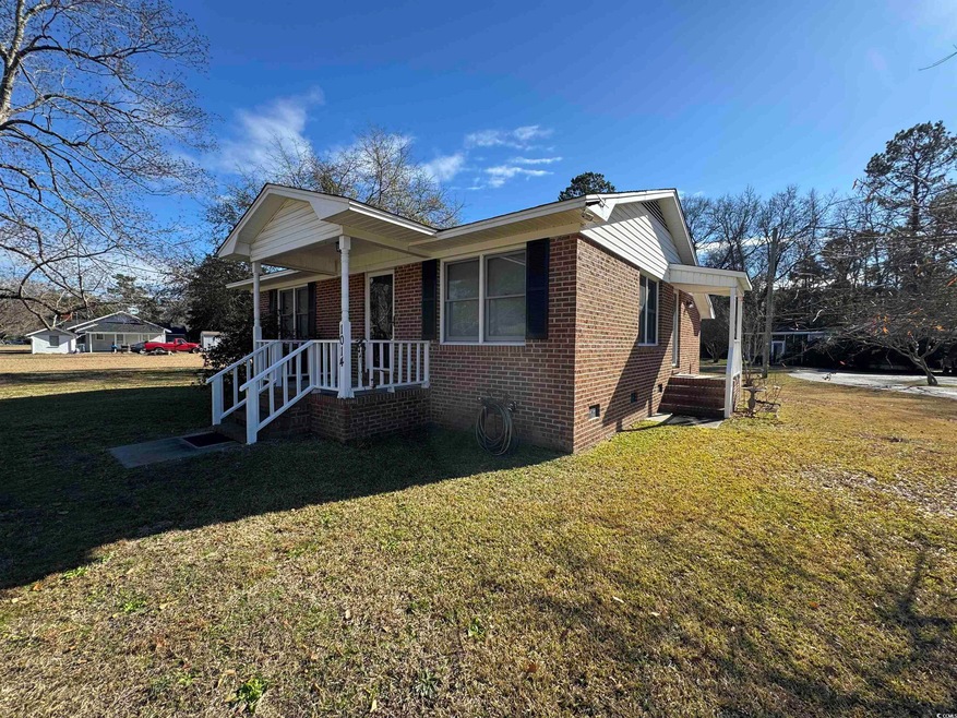 Exterior space with a front lawn and covered porch