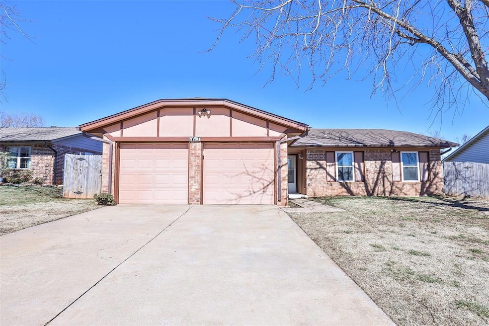 Ranch-style home with a front lawn and a garage