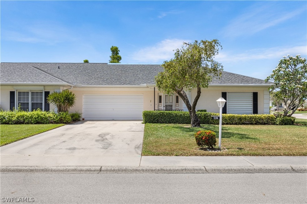 Ranch-style home featuring a front yard and a gara