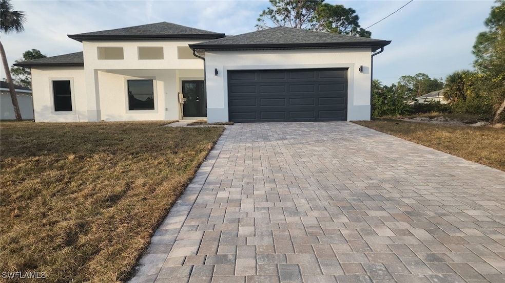 View of front facade with a garage and a front yar