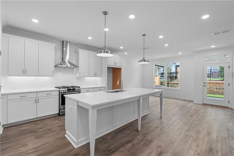 Gorgeous designer kitchen with large island. Imagine your family friends enjoying this space over your favorite meals ** Photos of previously built home, not actual home *
