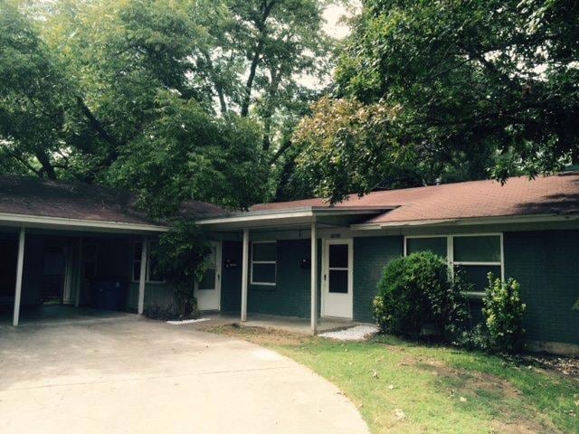 Ranch-style house with concrete driveway, covered