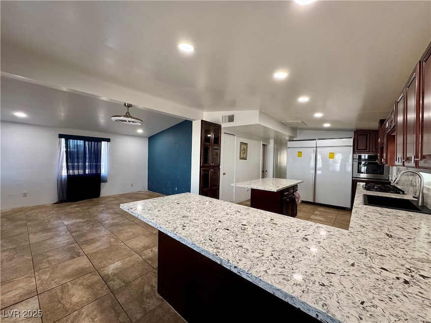 Kitchen with recessed lighting, a kitchen island,