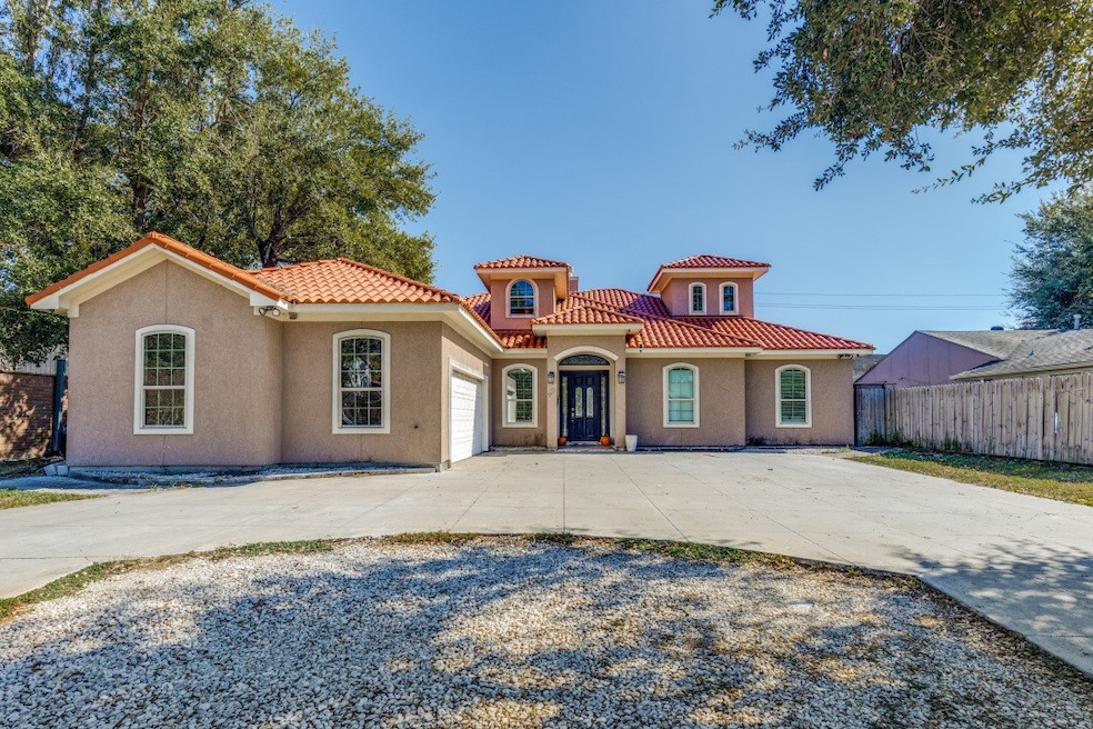Mediterranean / spanish house featuring concrete driveway, stucco siding, a garage, and a tiled roof