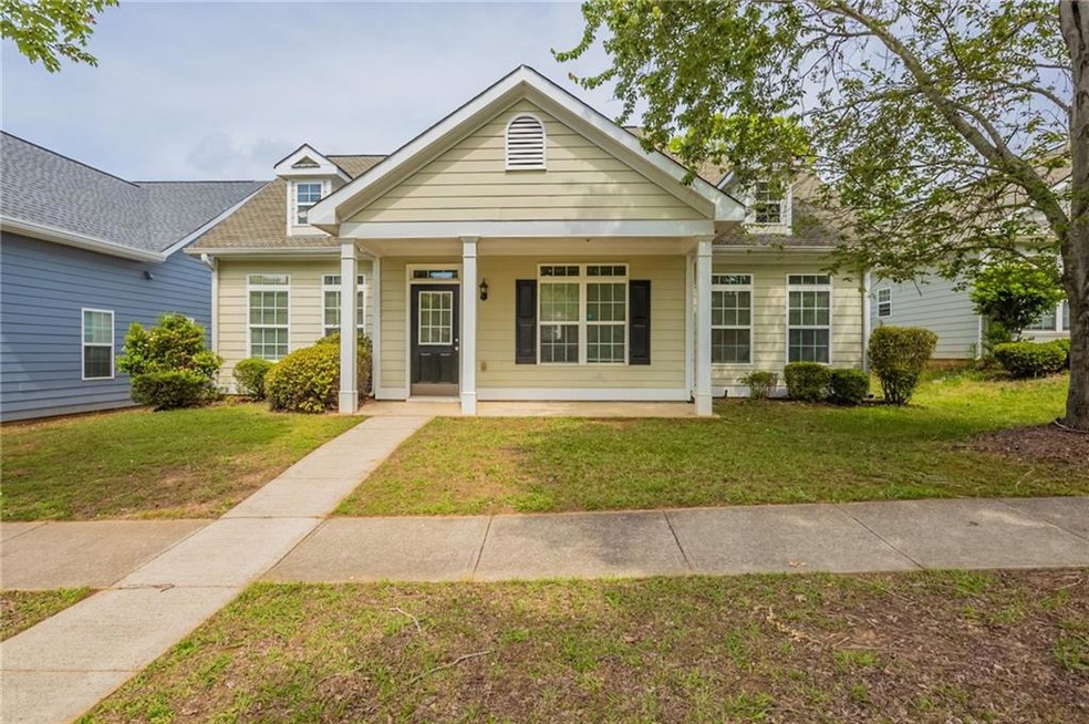 View of front of property featuring a porch, roof 