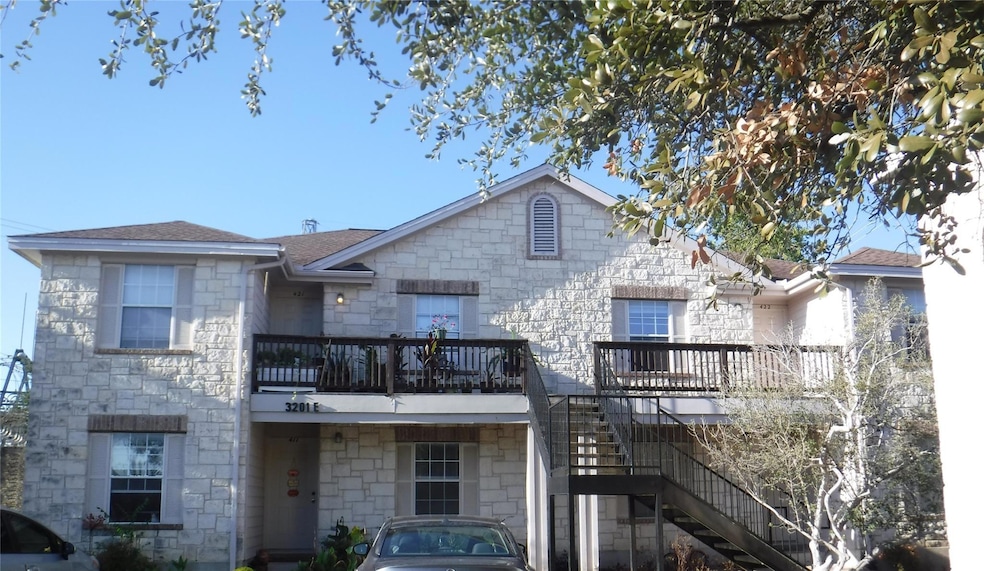 View of front of house with stone siding, stairway, and a deck