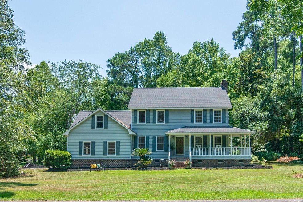 Colonial inspired home featuring a front yard and 