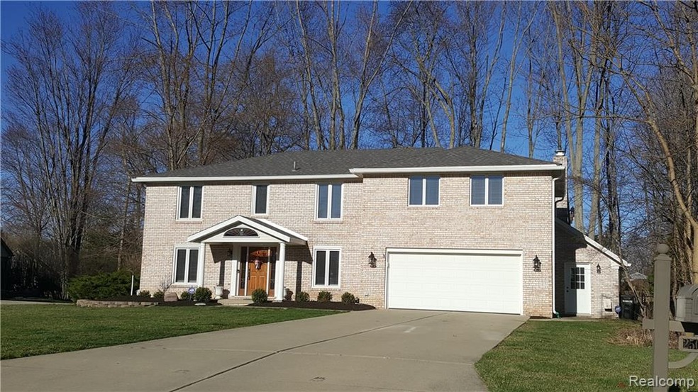 Front elevation shows attached shed.