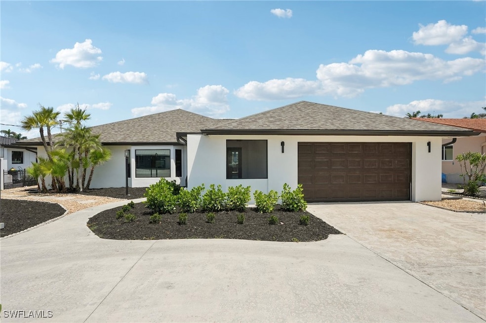 Ranch-style home with a garage, stucco siding, con