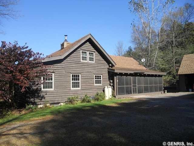 Exterior Front. Side view of house with large scre